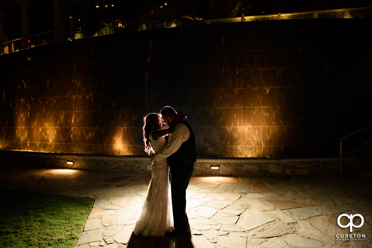 Bride and groom dancing in the park outside Larkin's on the river at the end of their reception.