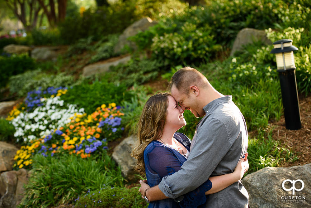 Future bride and groom having an engagement session in downtown Greenville SC at Falls Park.