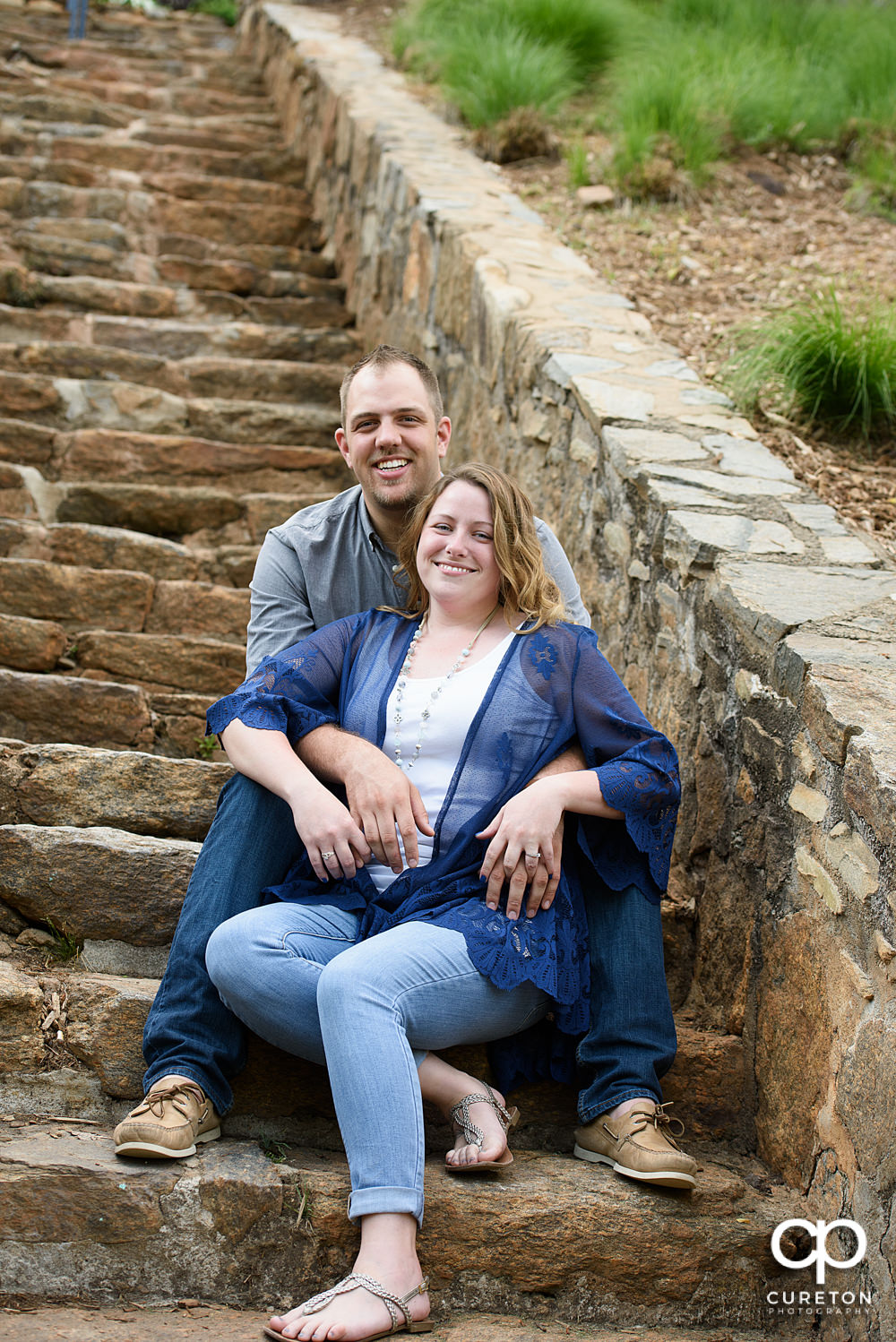 Future bride and groom having an engagement session in downtown Greenville SC at Falls Park.