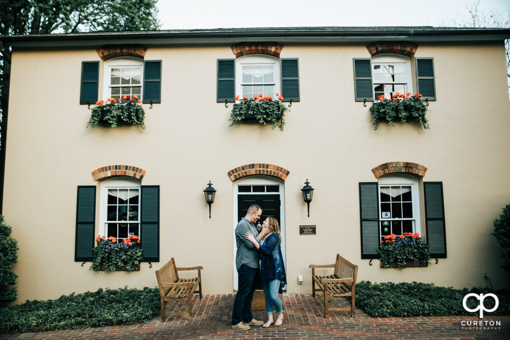 Future bride and groom having an engagement session in downtown Greenville SC at Falls Park.