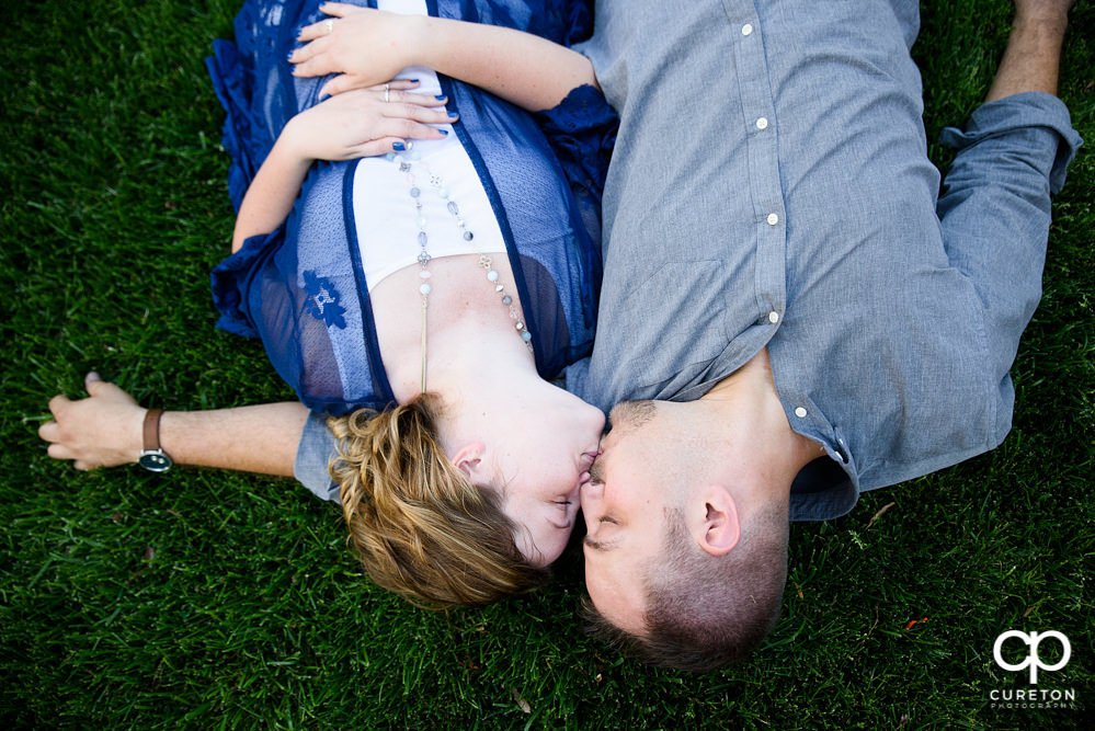 Future bride and groom having an engagement session in downtown Greenville SC at Falls Park.