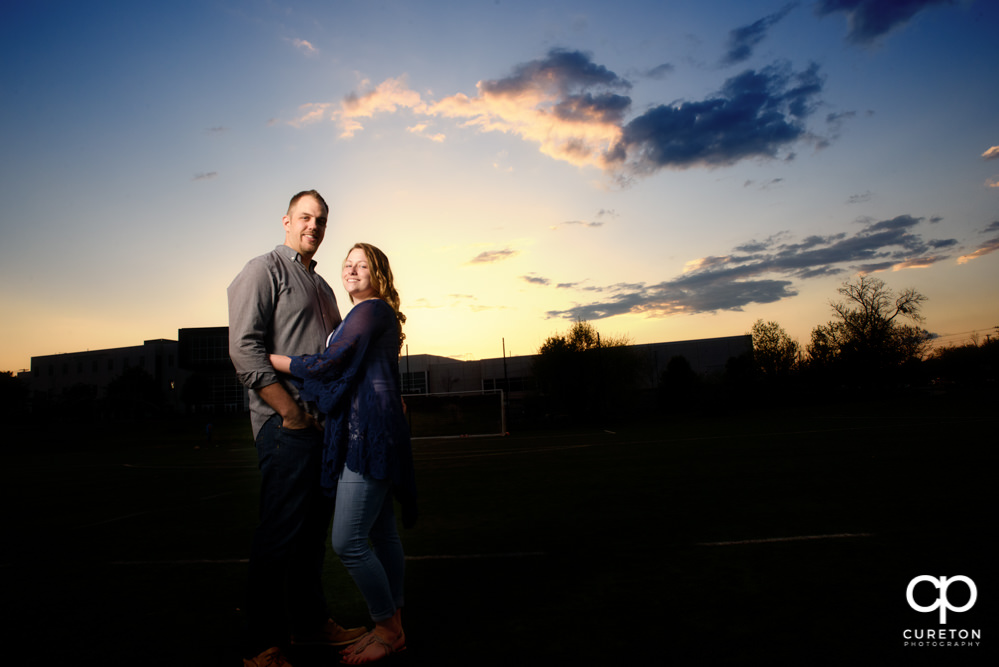 Future bride and groom having an engagement session in downtown Greenville SC at Falls Park.