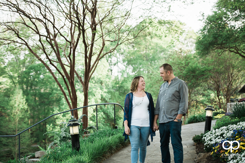 Future bride and groom having an engagement session in downtown Greenville SC at Falls Park.