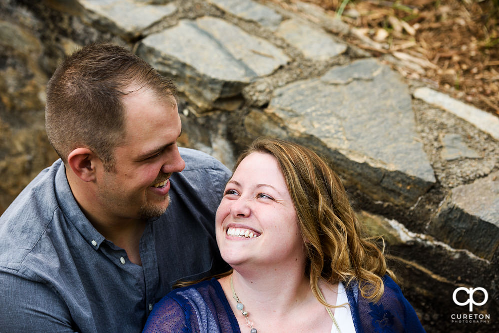 Future bride and groom having an engagement session in downtown Greenville SC at Falls Park.