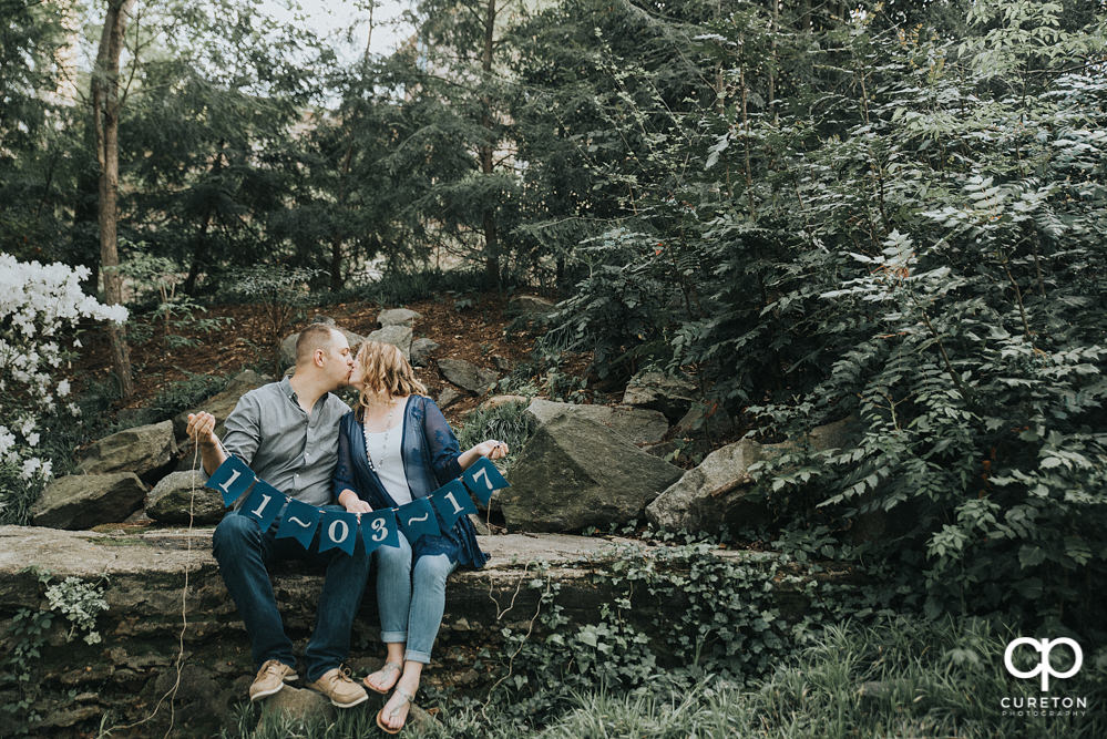 Future bride and groom having an engagement session in downtown Greenville SC at Falls Park.