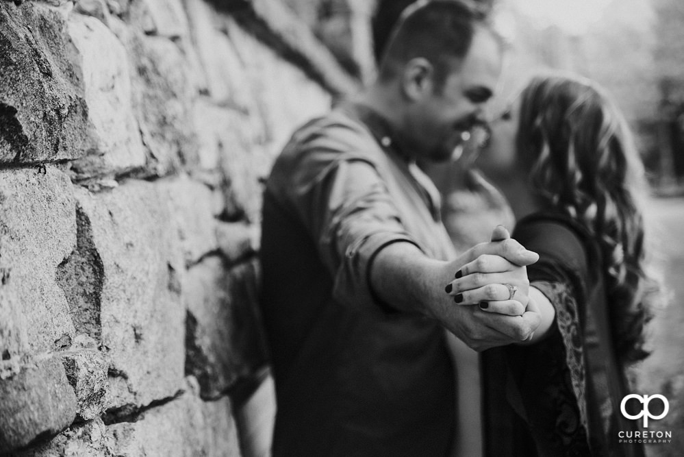 Future bride and groom having an engagement session in downtown Greenville SC at Falls Park.