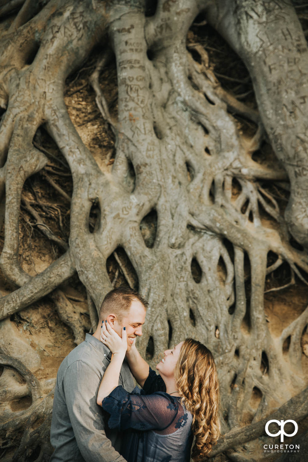 Future bride and groom having an engagement session in downtown Greenville SC at Falls Park.