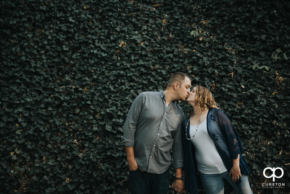 Future bride and groom having an engagement session in downtown Greenville SC at Falls Park.