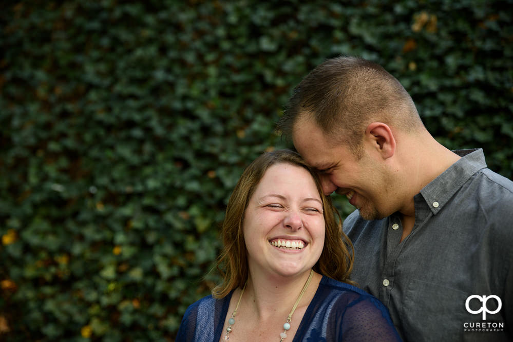 Future bride and groom having an engagement session in downtown Greenville SC at Falls Park.