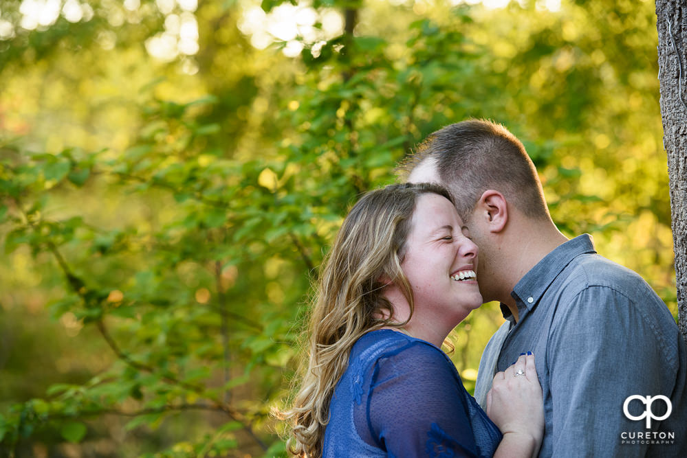 Future bride and groom having an engagement session in downtown Greenville SC at Falls Park.