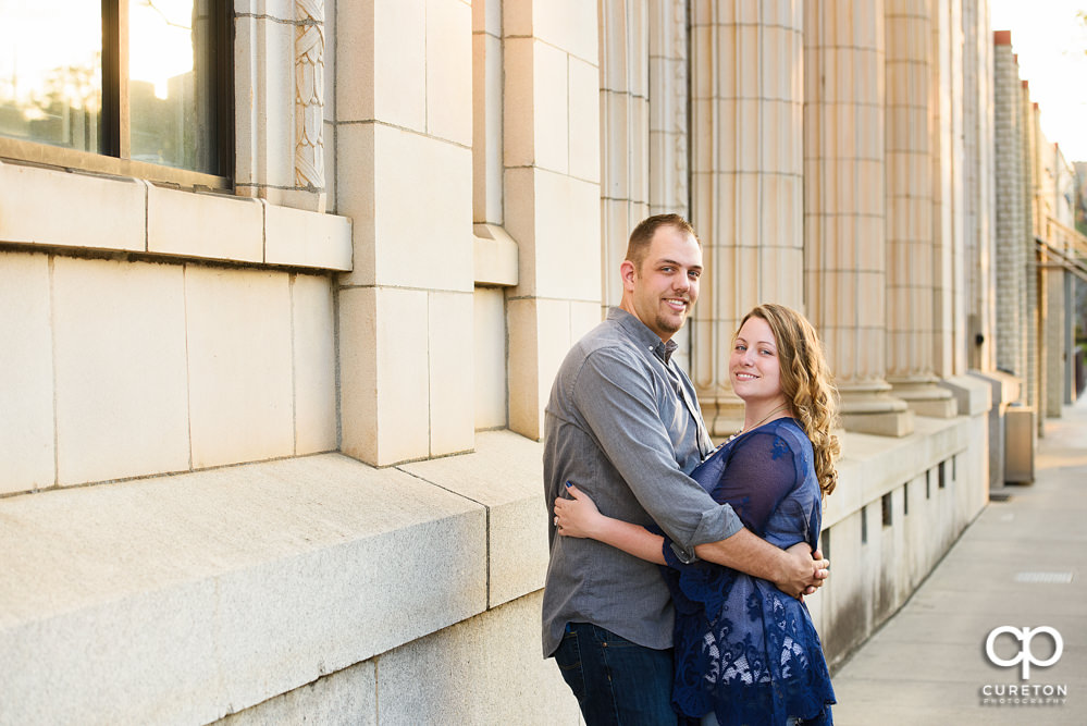 Future bride and groom having an engagement session in downtown Greenville SC at Falls Park.