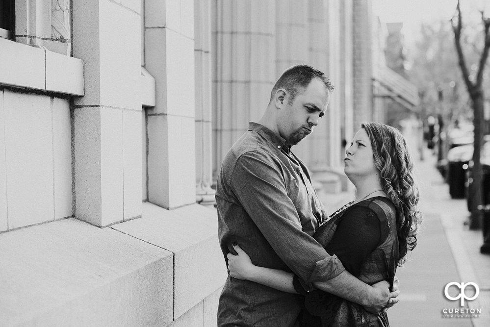 Future bride and groom having an engagement session in downtown Greenville SC at Falls Park.