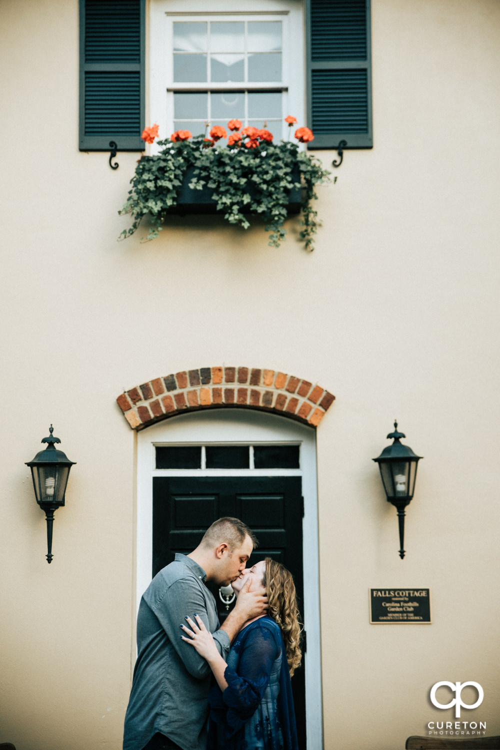 Future bride and groom having an engagement session in downtown Greenville SC at Falls Park.