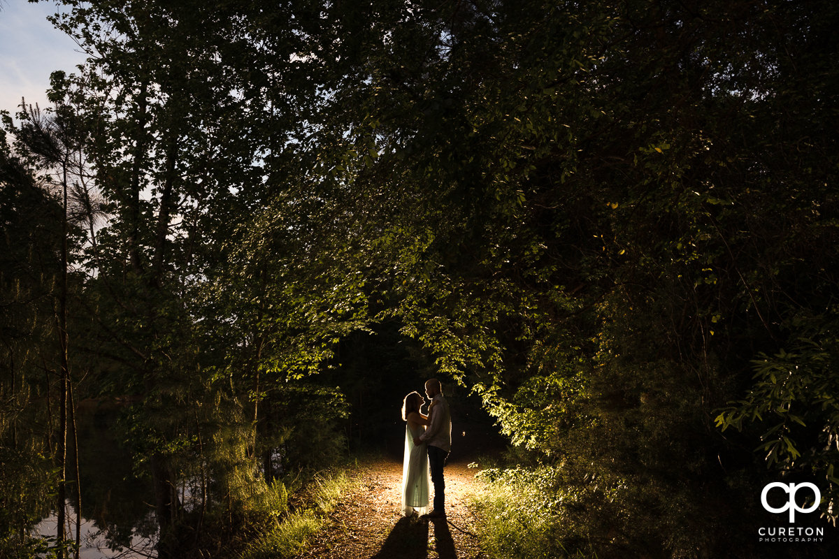 Bride and groom dancing in the woods during a family farm engagement session in Gray Court,SC.