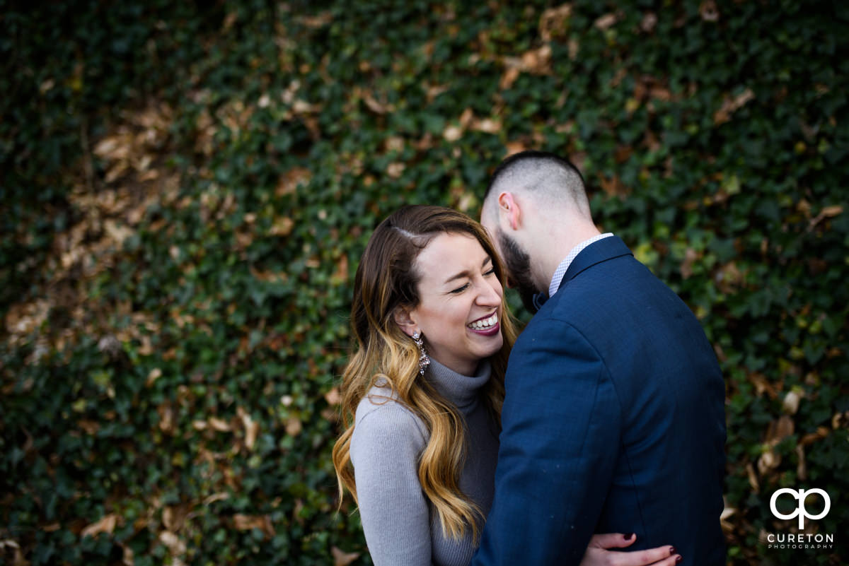 Groom making his bride laugh.