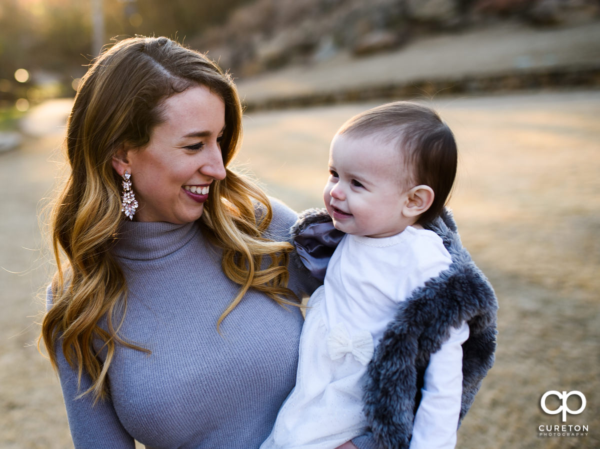 Mother holding her daughter.