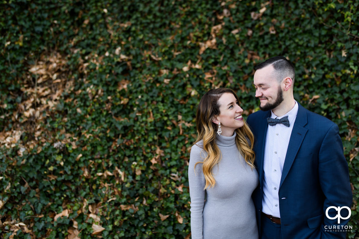 Engaged couple smiling at each other during a Falls Park engagement session.