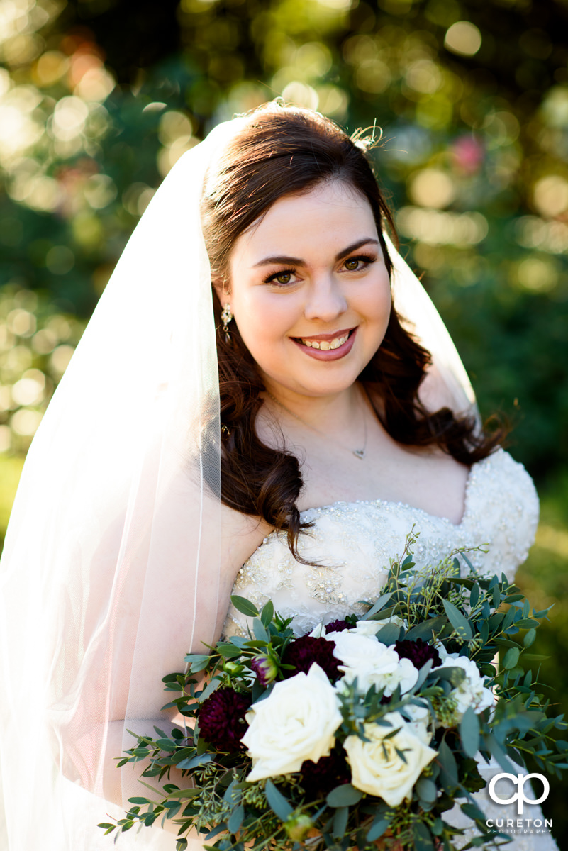 Bride holding her bouquet at a Furman University golden hour bridal session.