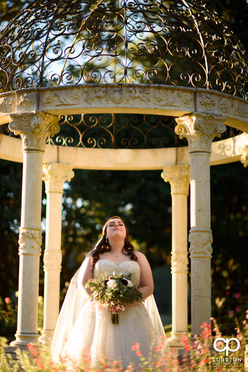 Bride glowing in sunlight during her bridal session at Furman University.
