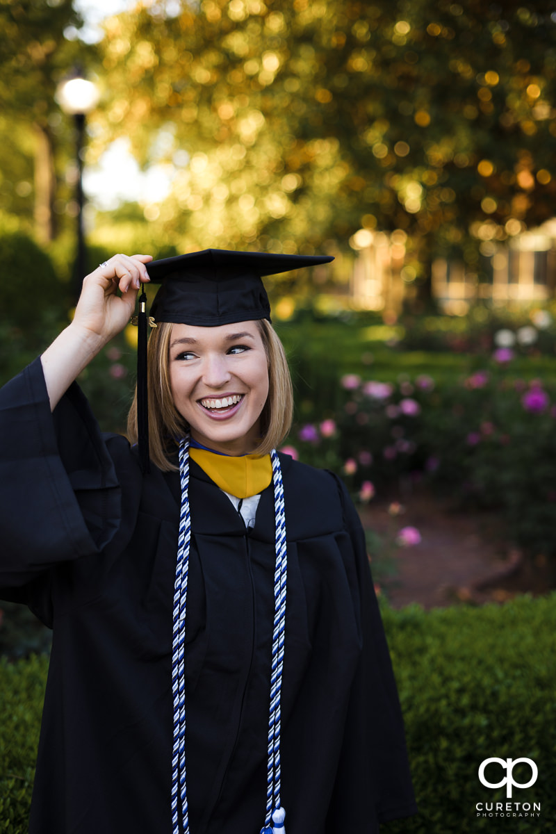 Furman graduate holding her cap.