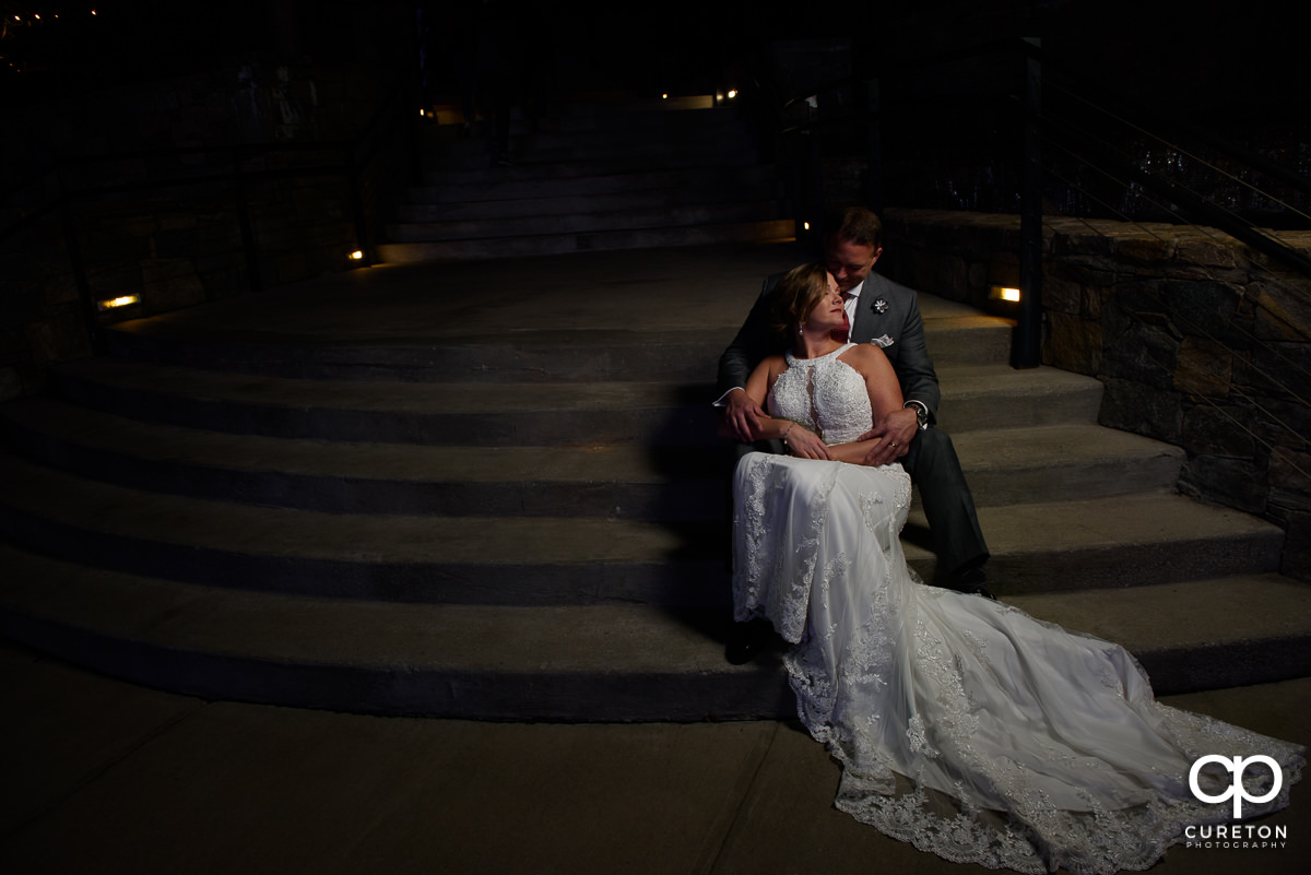 Bride and groom on the steps by the Lazy Goat in downtown Greenville,SC.