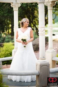 A bride posing in teh rose garden at Furman during her bridal session.