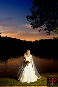 Bride by the lake at Furman during an epic sunset at her bridal session.