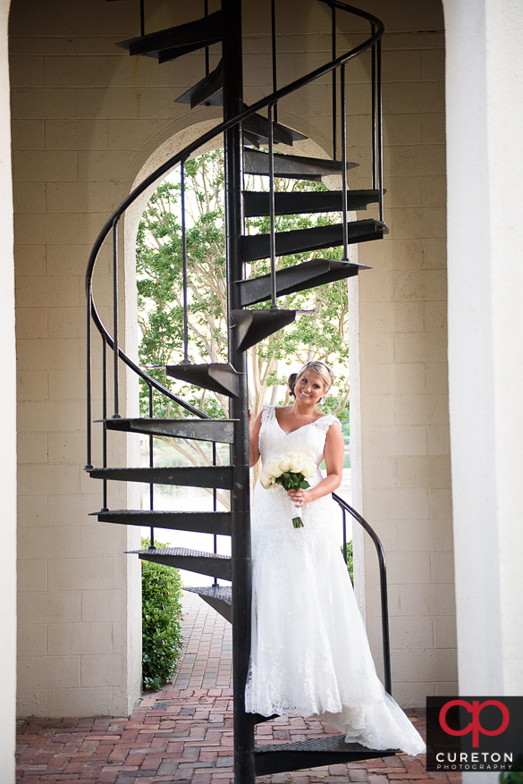 Bride standing on a staircase outside.