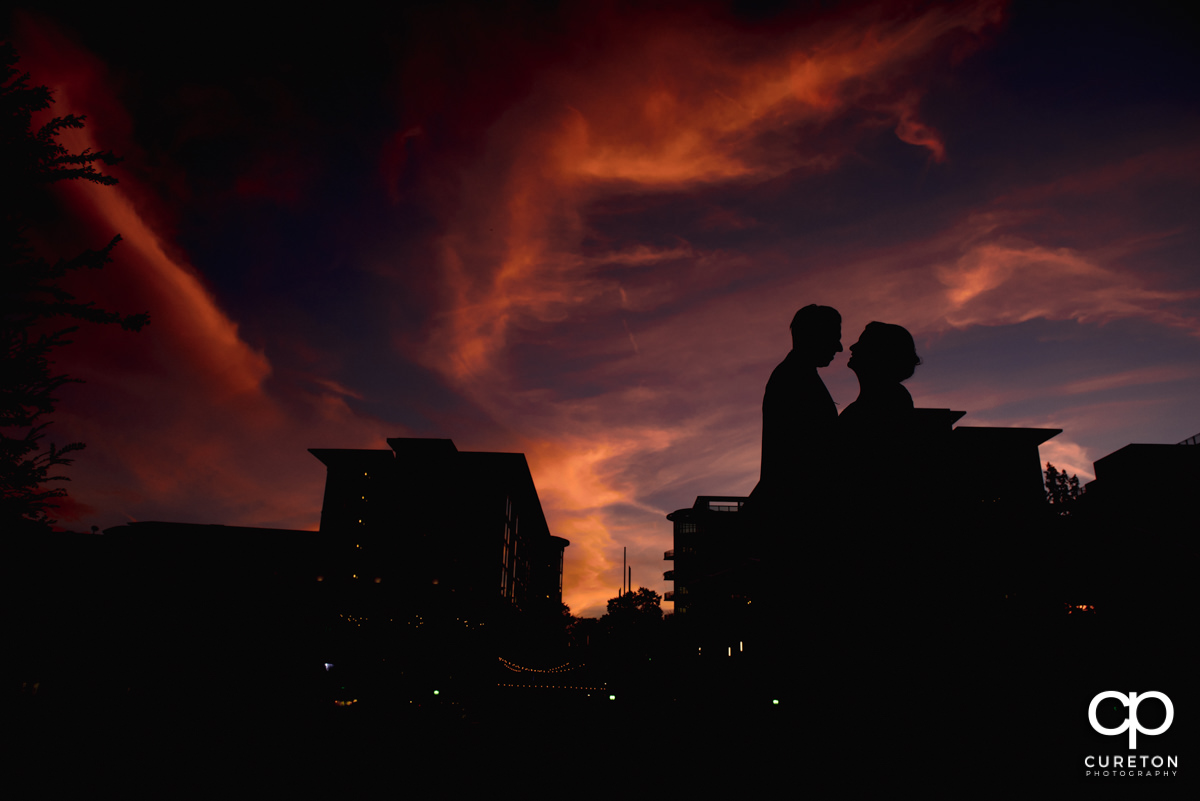 Silhouette of a bride and groom at sunset in downtown Greenville,SC.