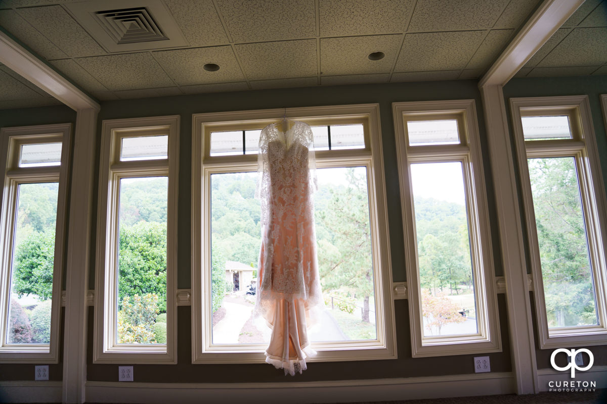Bride's dress hanging in the clubhouse at the Cliffs at Glassy.