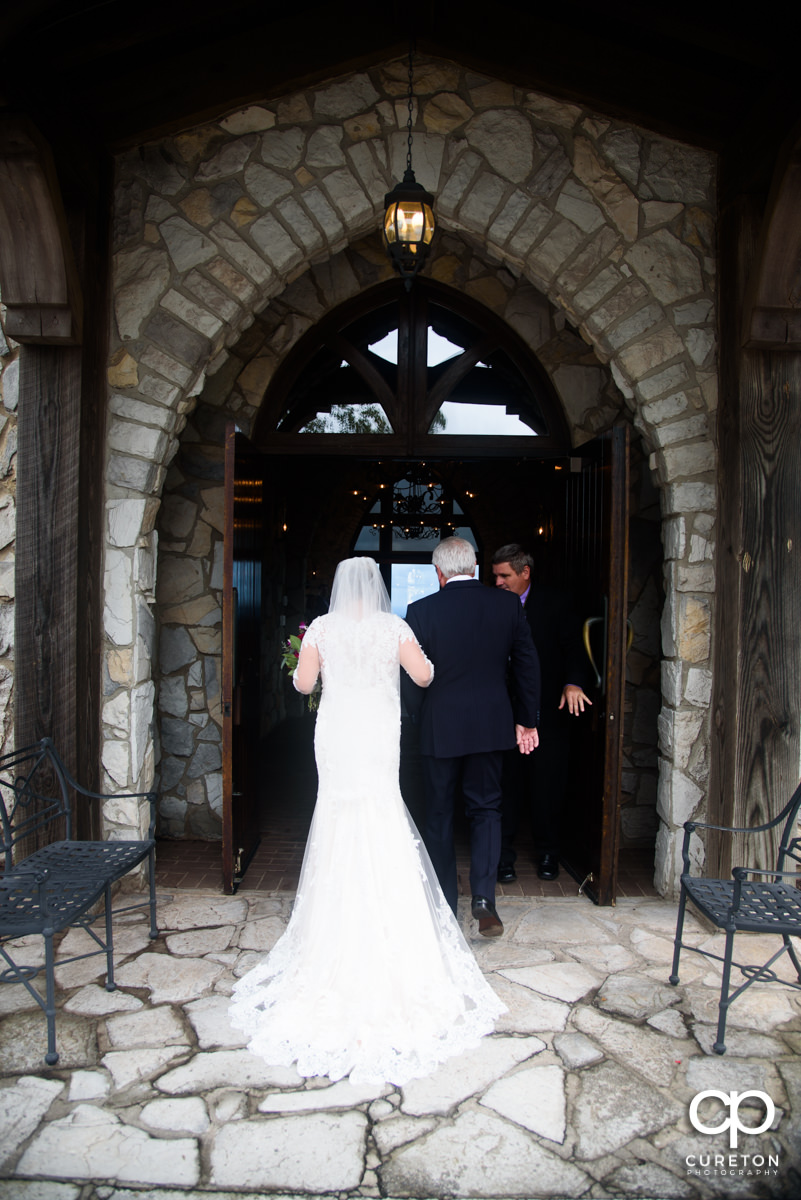 Bride and her dad walking into the chapel.