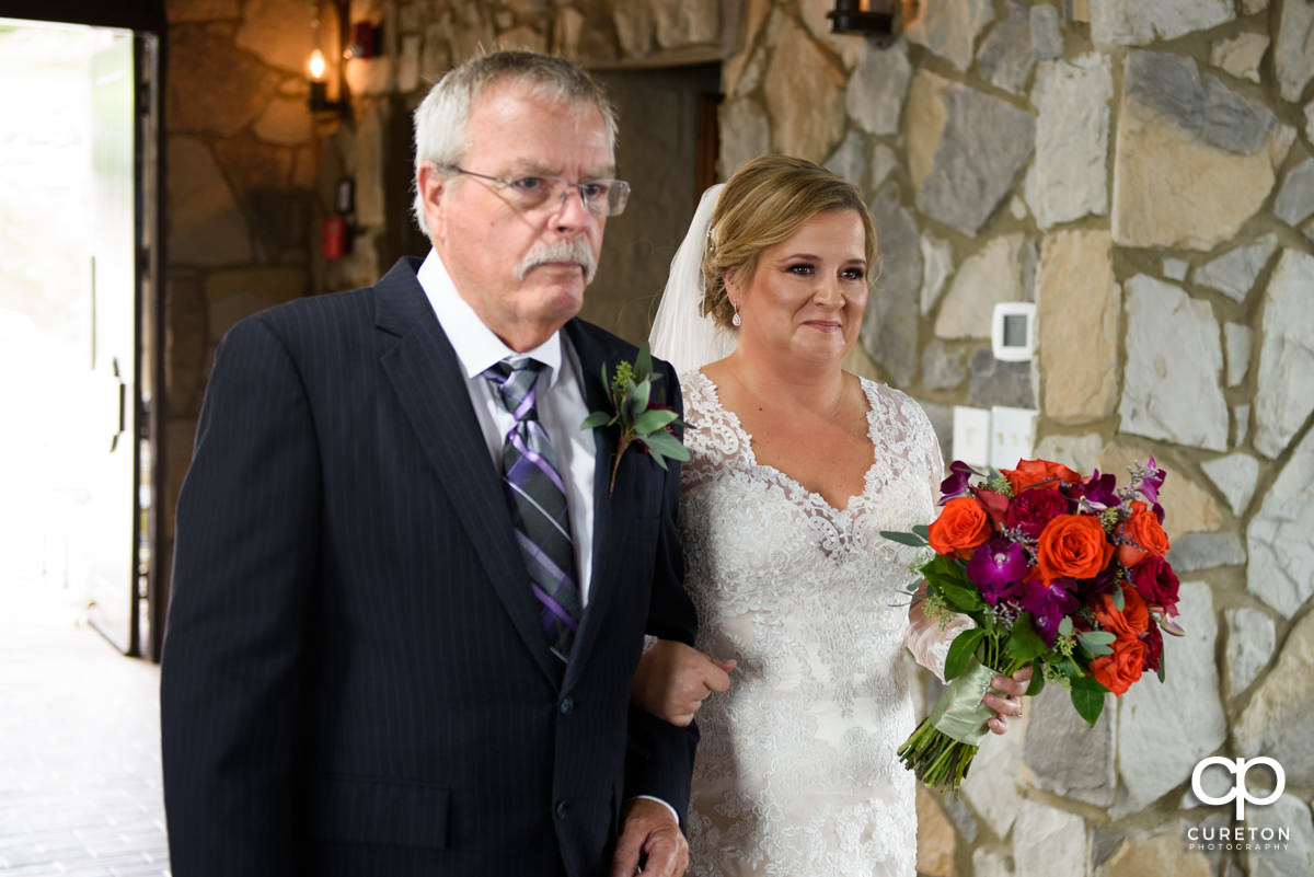 Bride and her father walking down the aisle at Glassy Chapel.