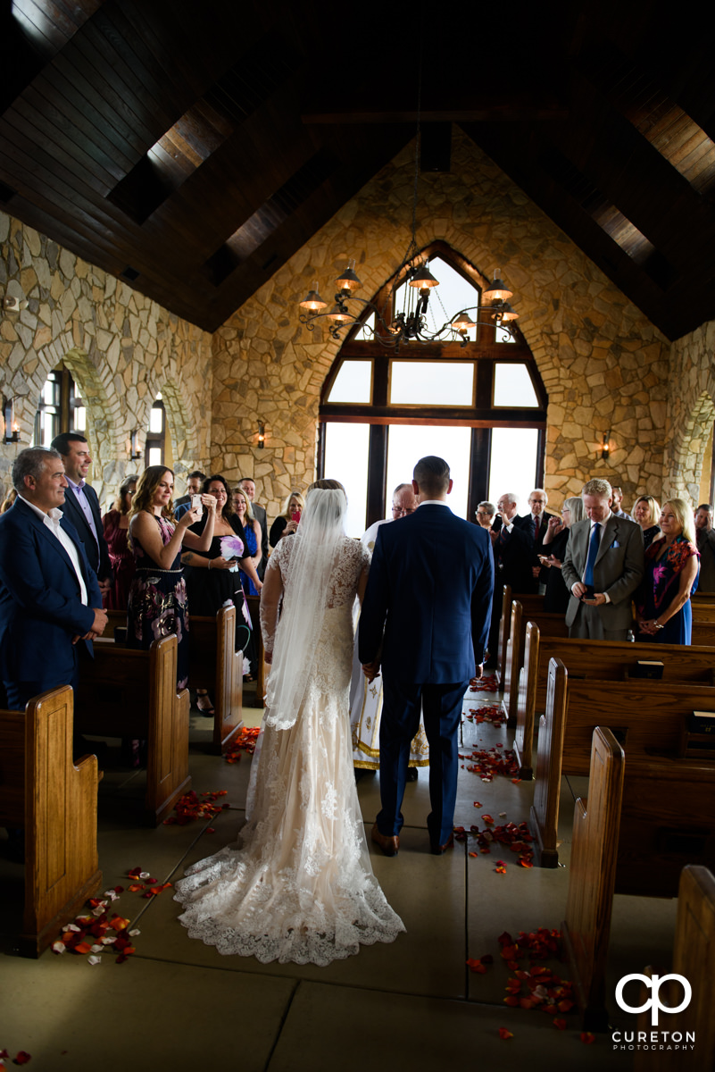 Bride and groom standing at the altar at Glassy Chapel during a wedding ceremony.