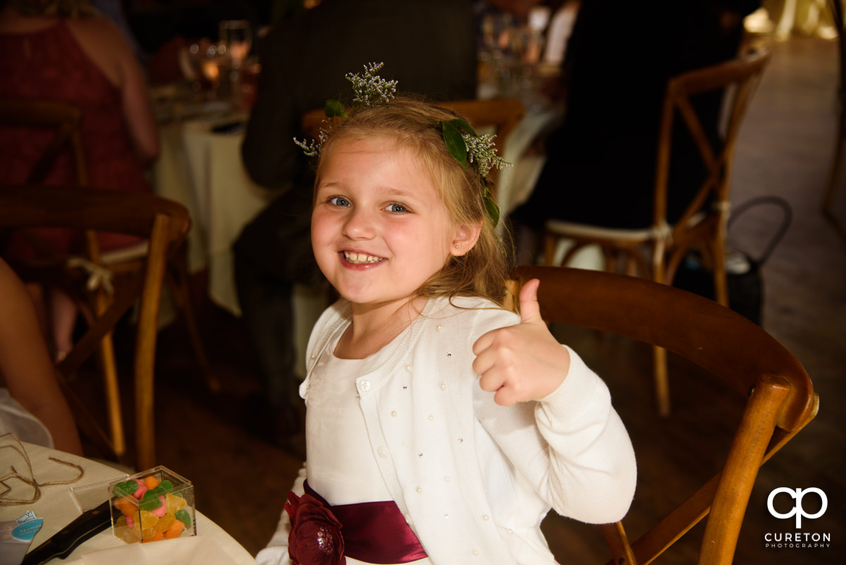 Flower girl giving the thumbs up.