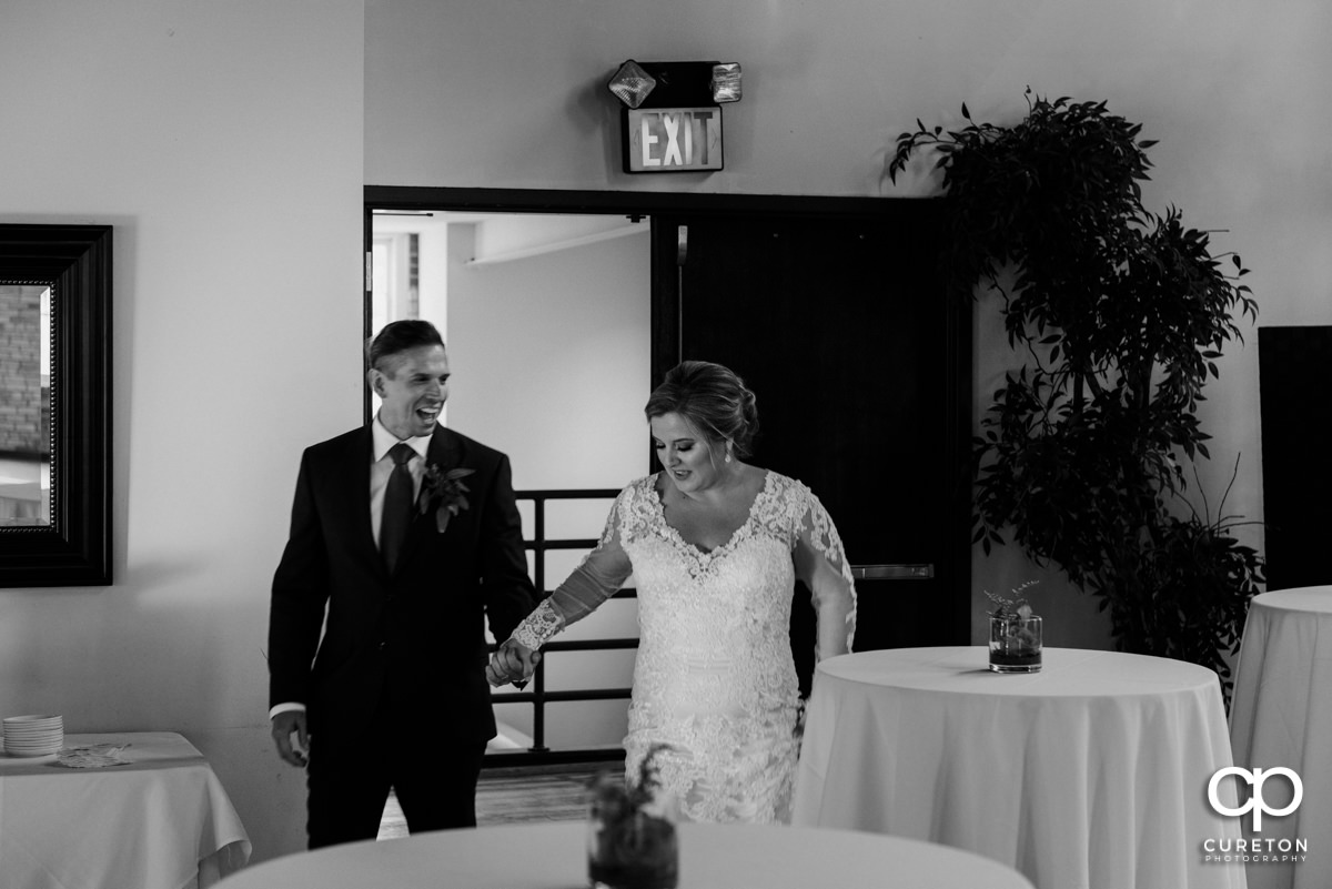 Bride and groom making an entrance to the reception.