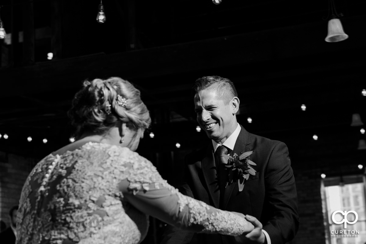 Groom laughing during their first dance.