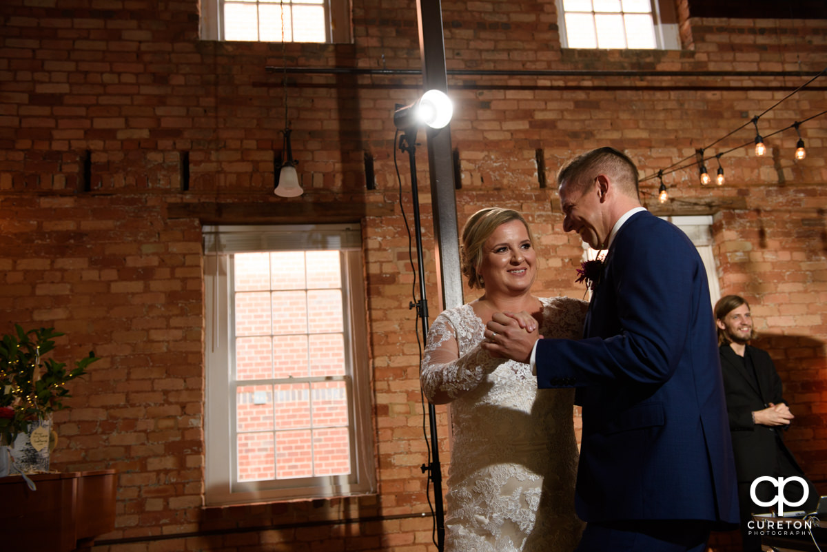 Bride smiling during the first dance.