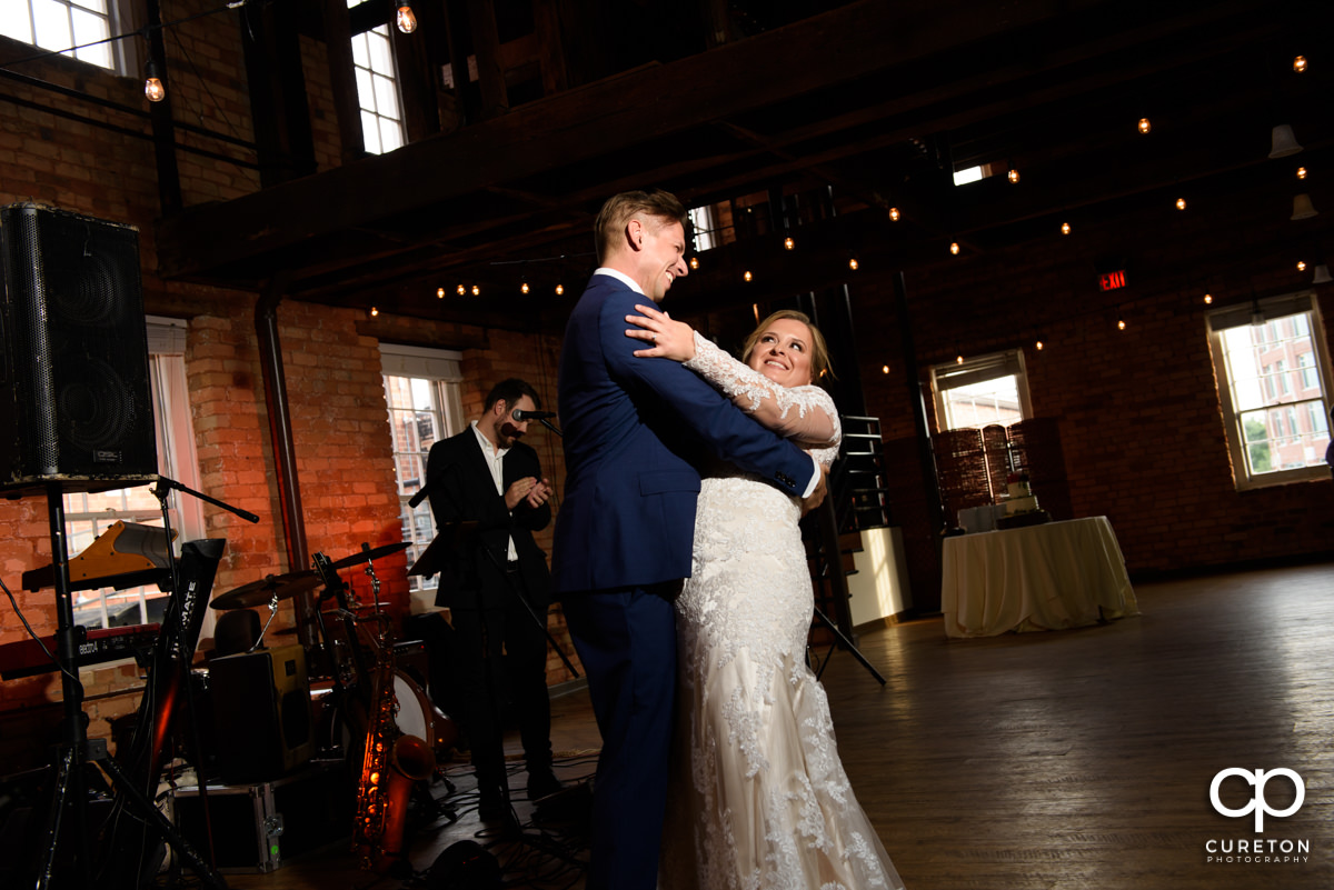 Groom dipping the bride during their first dance at their Larkin's Cabaret Room wedding reception in downtown Greenville,SC.