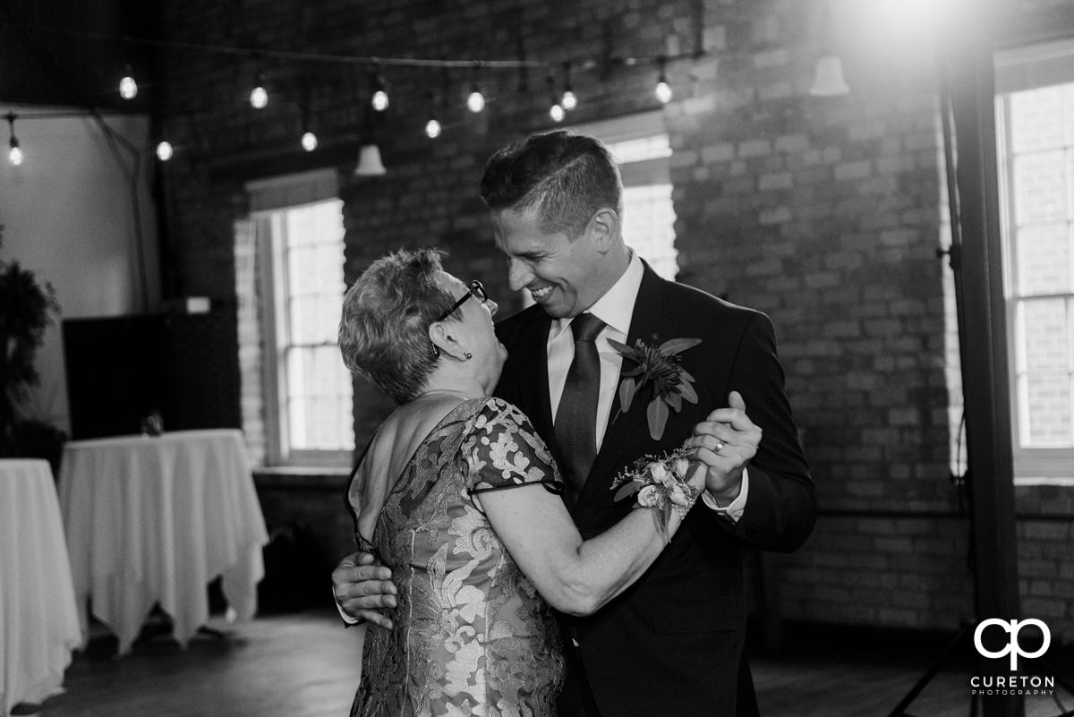 Groom dancing with his mother at the wedding reception.