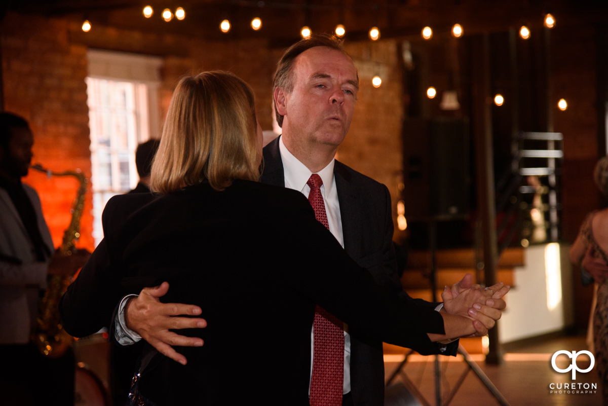 Wedding guests dancing at the reception.