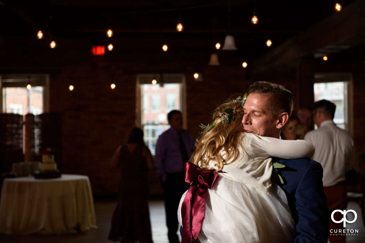 Groom dancing with the flower girl at the wedding reception.