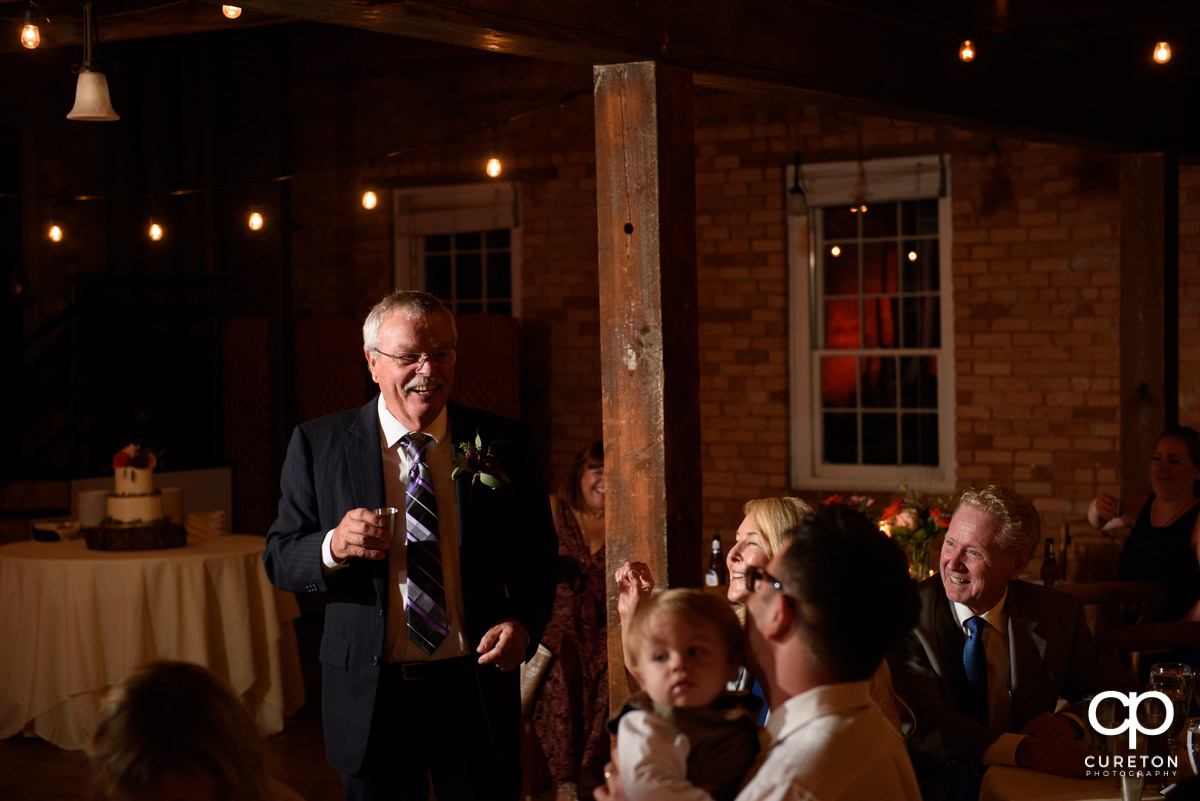 Bride's father giving a toast at the reception.