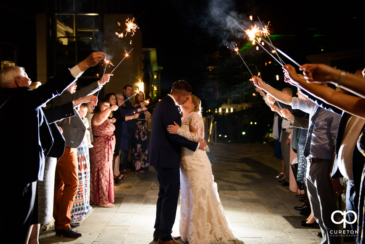 Bride and groom making a grand sparkler exit from their wedding reception at Larkin's Cabaret Room in downtown Greenville,SC.