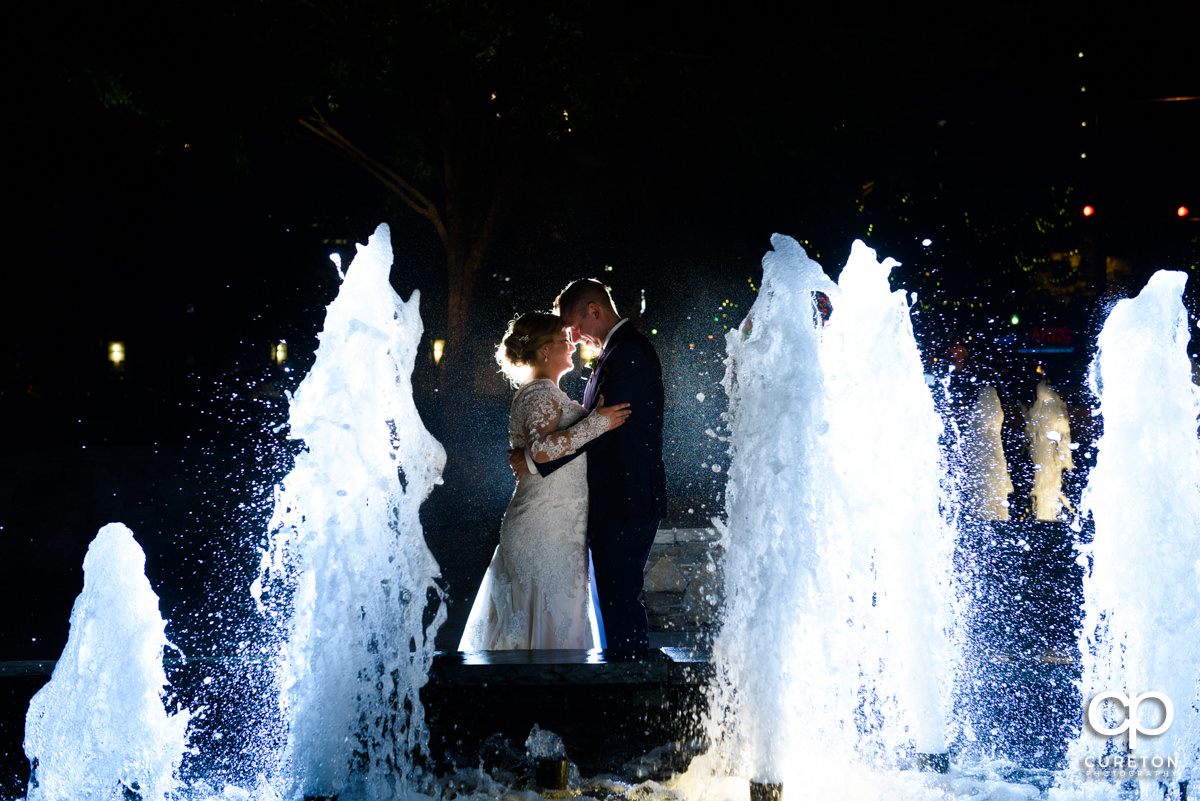 Bride and groom dancing in the fountains at their Larkin's Cabaret Room wedding reception in downtown Greenville,SC.