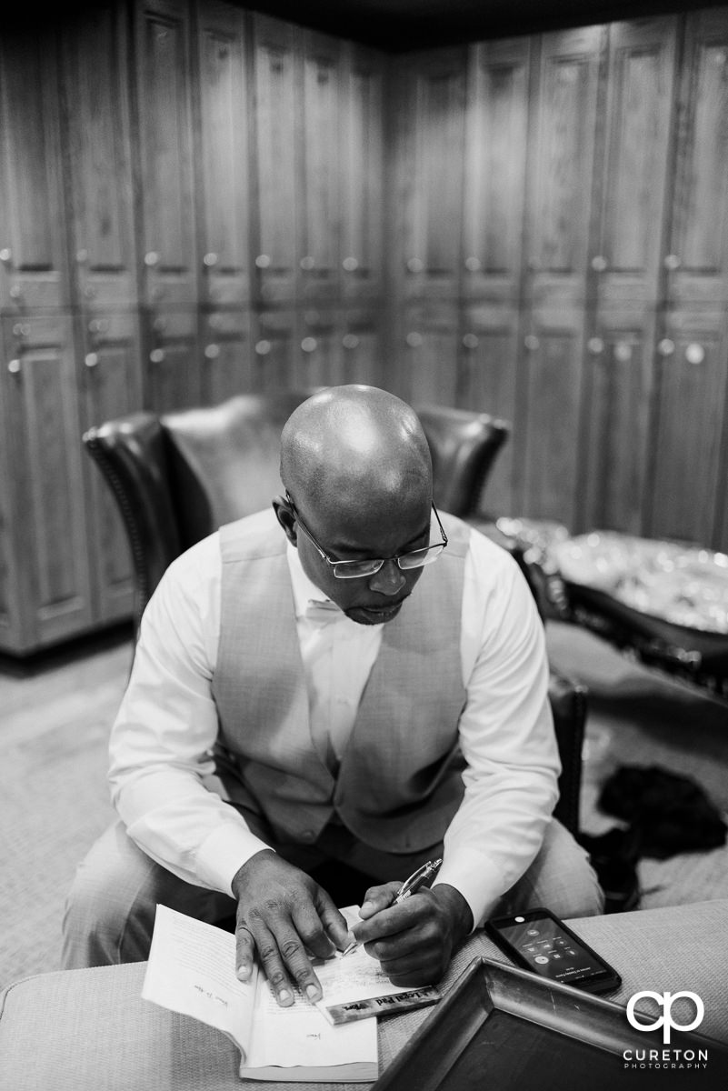 Groom writing a letter to his bride.
