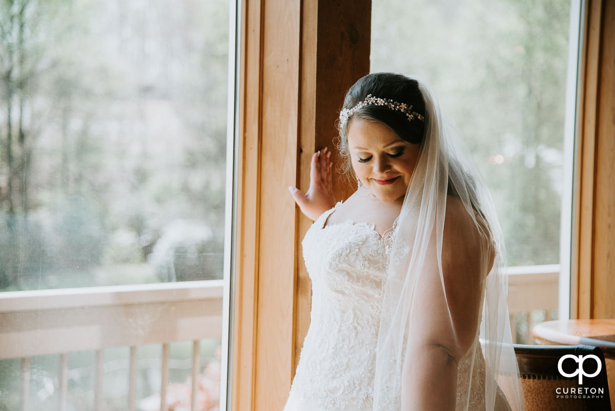 Bride looking at her veil.