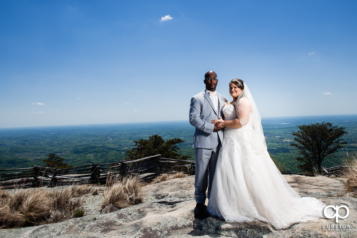 Bride and groom on a mountain top.