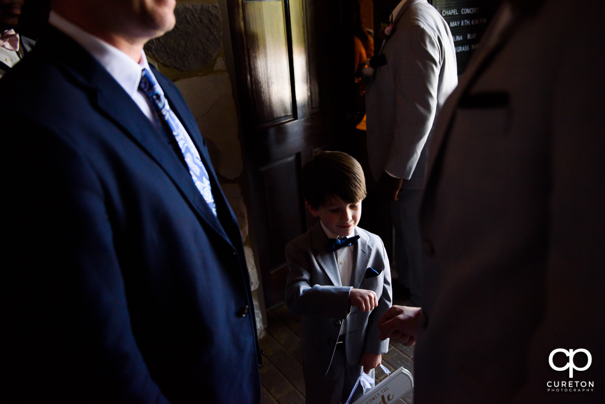 Ring bearer fist bumping a groomsmen before the wedding ceremony.