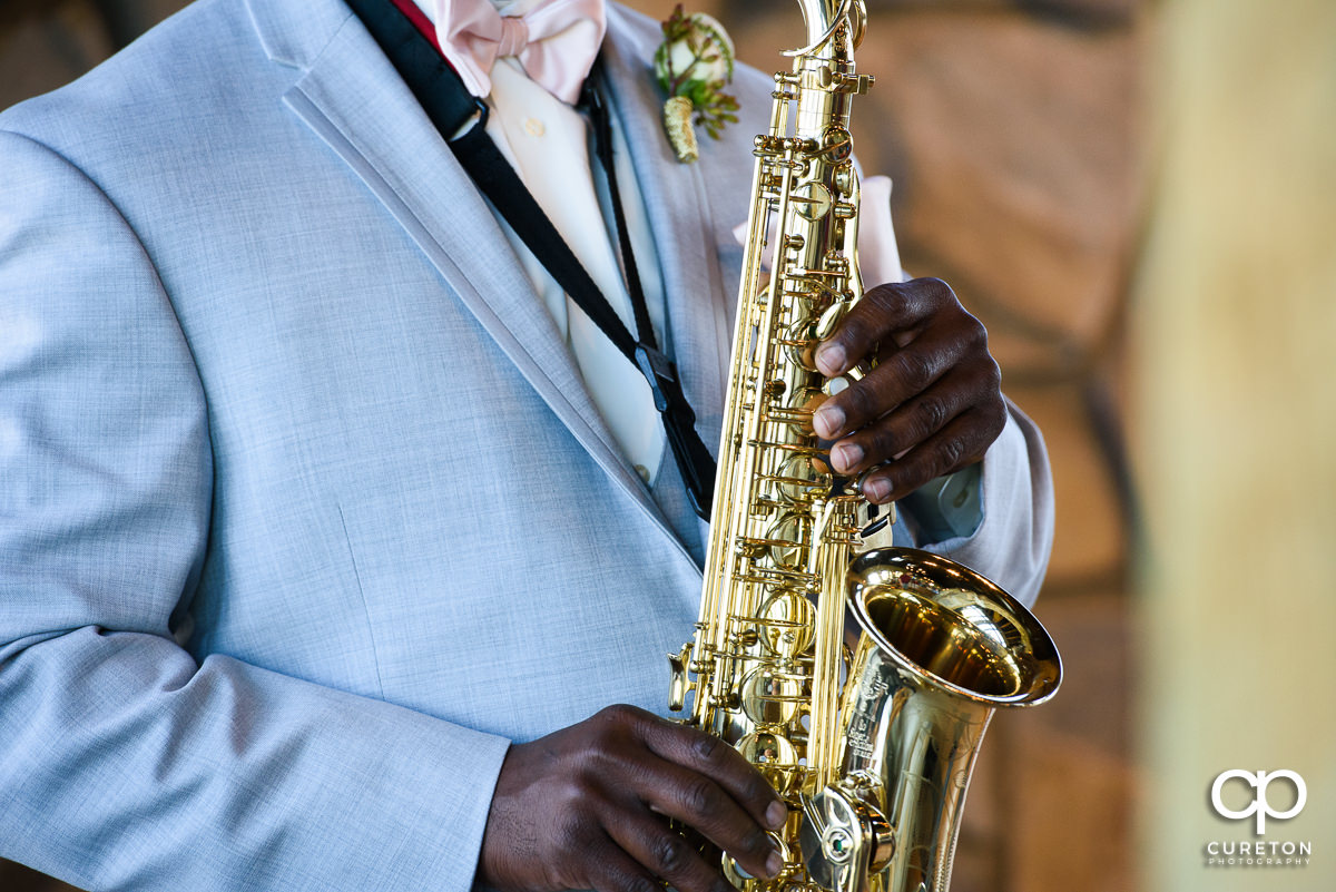 Groom playing a saxophone.
