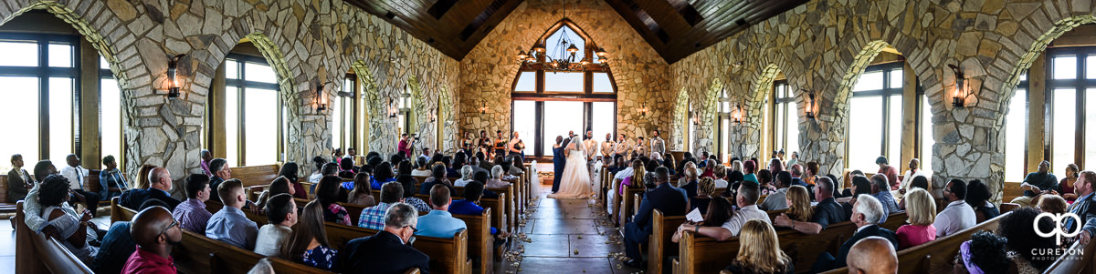 Wide panorama of a wedding ceremony at Cliffs Glassy Chapel.